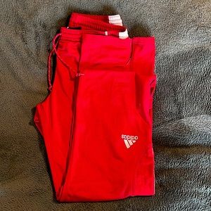 Red adidas drawstring sweatpants with stylish zipper at bottom